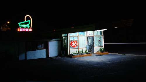 supai motel white and multicolored building near green neon signage seligman
